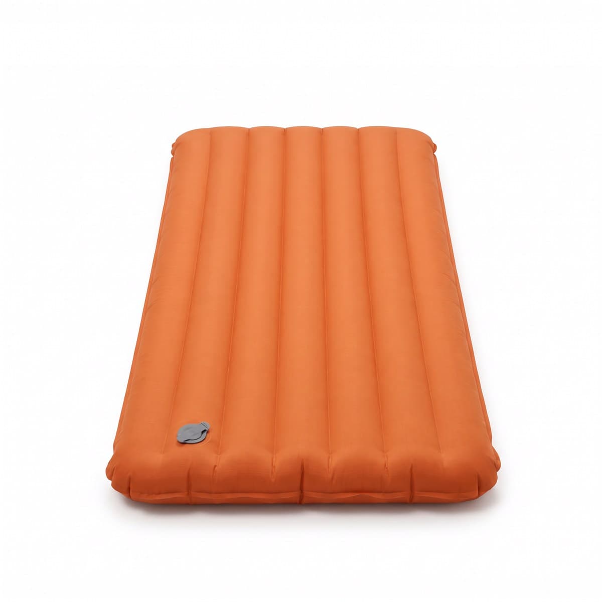 An orange inflatable sleeping pad with lengthwise baffles and a grey flat valve, inflated